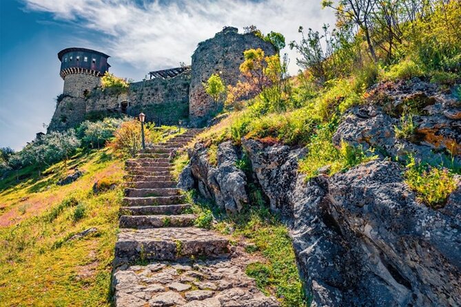 From Tirana: Hiking to Pellumbas cave and Petrela Castle - Entering Pellumbas Cave with a torch and helmet