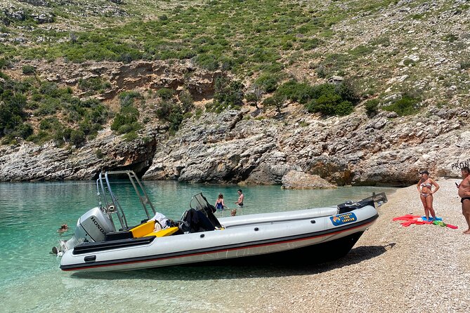Speed Boat Tour to National Park and Grama Bay - Grama Bay, inscriptions above the water